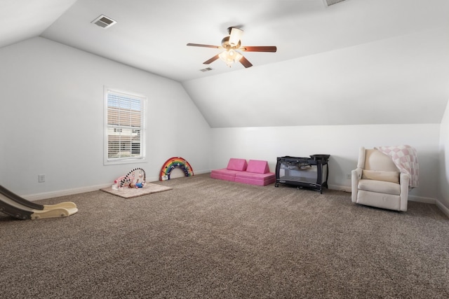 rec room with carpet floors, lofted ceiling, visible vents, a ceiling fan, and baseboards