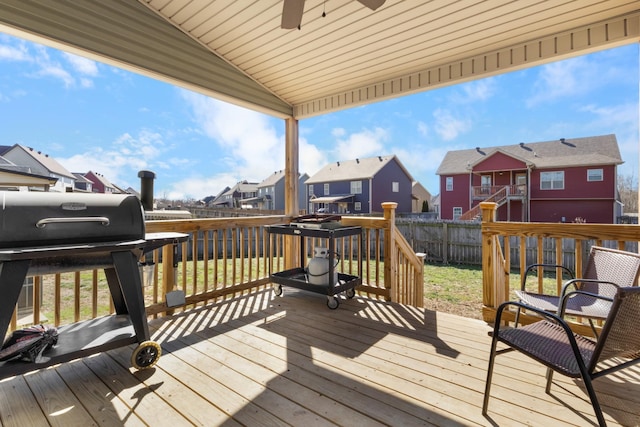 deck with a residential view, fence, grilling area, and ceiling fan