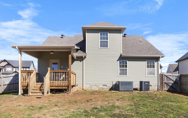 rear view of house with a yard, central AC, and a fenced backyard