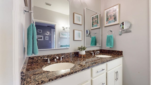 full bathroom with double vanity, a sink, and visible vents