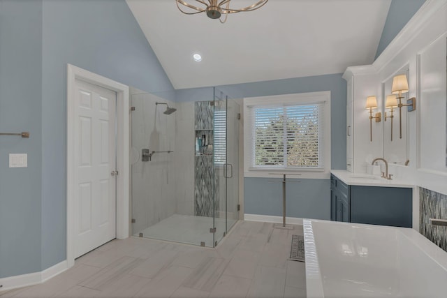 bathroom featuring lofted ceiling, a tub, a shower stall, and baseboards