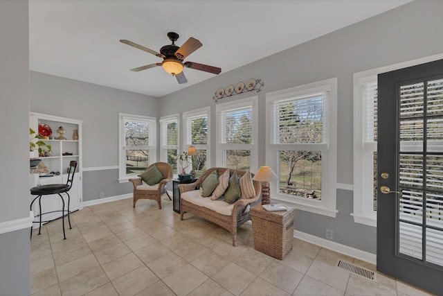 sunroom / solarium with visible vents and ceiling fan