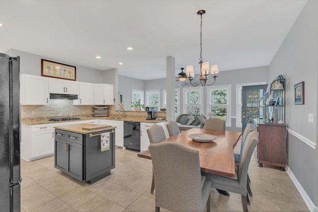 dining room featuring a chandelier, recessed lighting, light tile patterned flooring, and baseboards