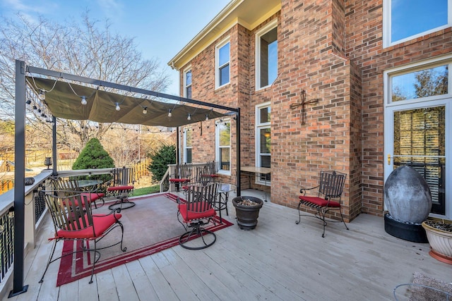 wooden terrace featuring outdoor dining area