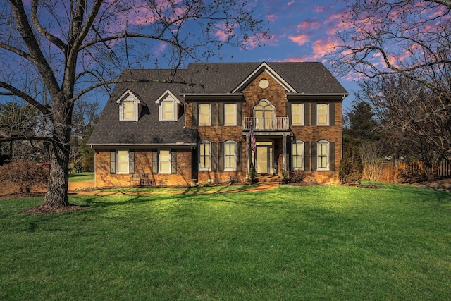 view of front of property with a front lawn and brick siding