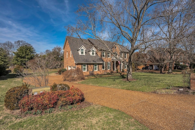 view of front of property with brick siding and a front lawn