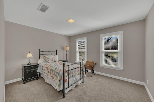 bedroom with light carpet, visible vents, and baseboards