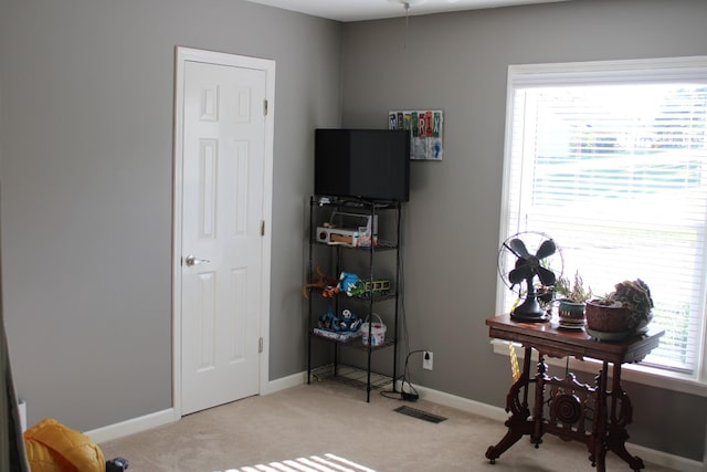 rec room featuring visible vents, light carpet, and baseboards