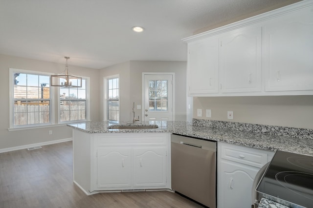 kitchen with a sink, white cabinets, and stainless steel dishwasher