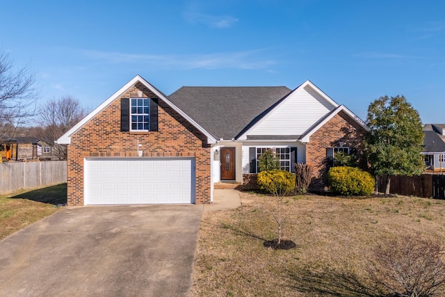 traditional-style home with driveway, a garage, brick siding, fence, and a front yard