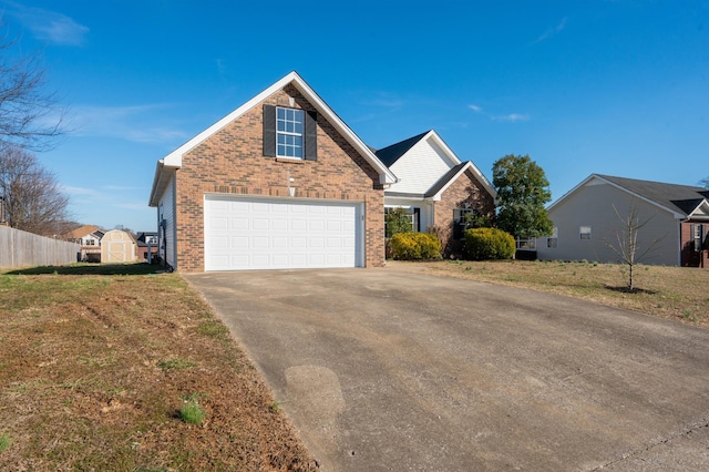 traditional-style house with brick siding, a storage shed, a front yard, an outdoor structure, and driveway