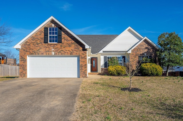 traditional-style home featuring brick siding, driveway, an attached garage, and fence