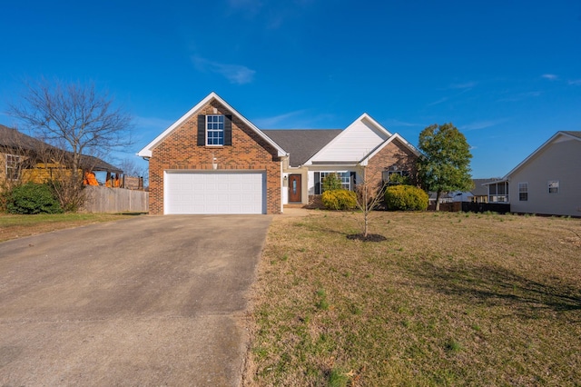 view of front of house featuring brick siding, an attached garage, fence, driveway, and a front lawn