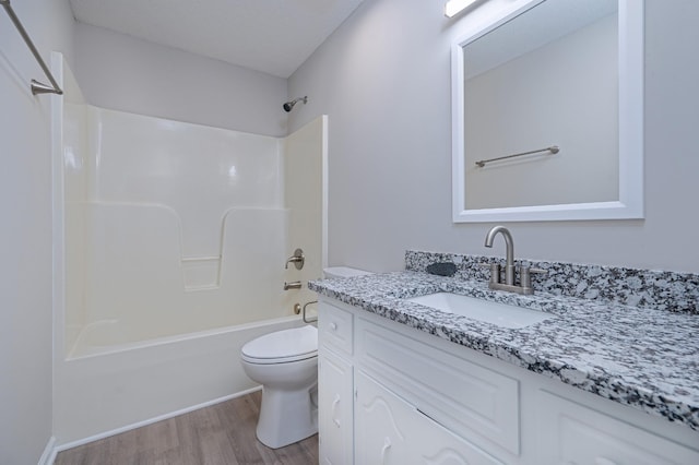 full bath with shower / bathing tub combination, vanity, toilet, and wood finished floors