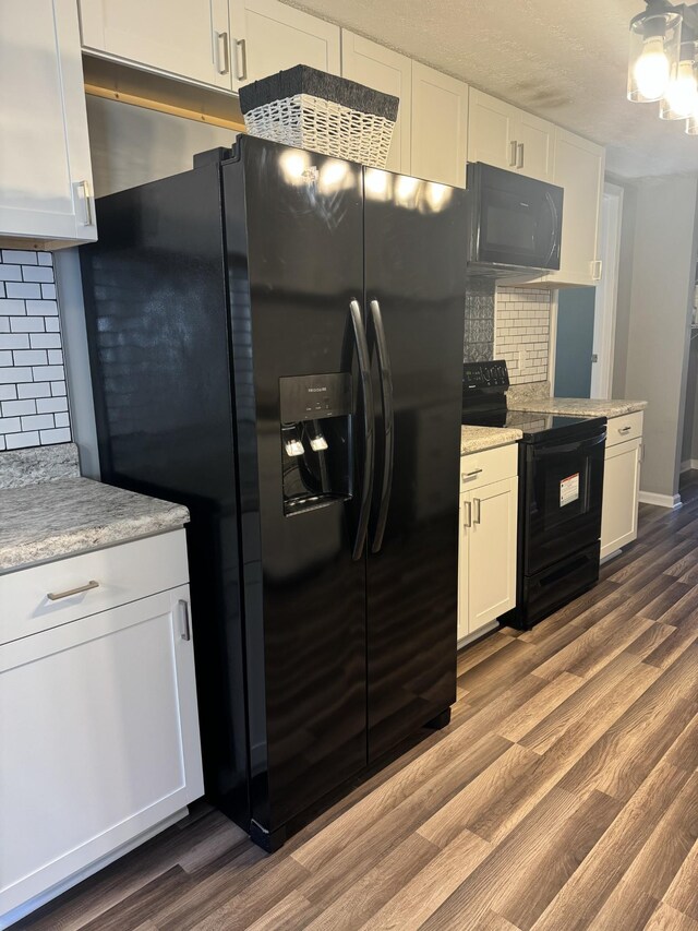 kitchen featuring black appliances, white cabinets, dark wood-style floors, and backsplash