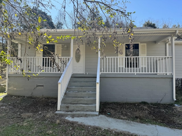 view of front of property with stairs and a porch