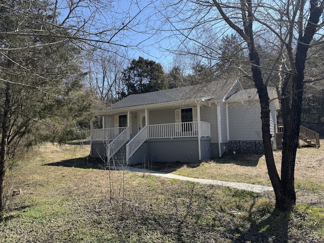 view of front of house featuring roof with shingles and covered porch