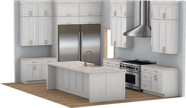 kitchen with white cabinets, appliances with stainless steel finishes, a kitchen island with sink, wall chimney range hood, and a sink