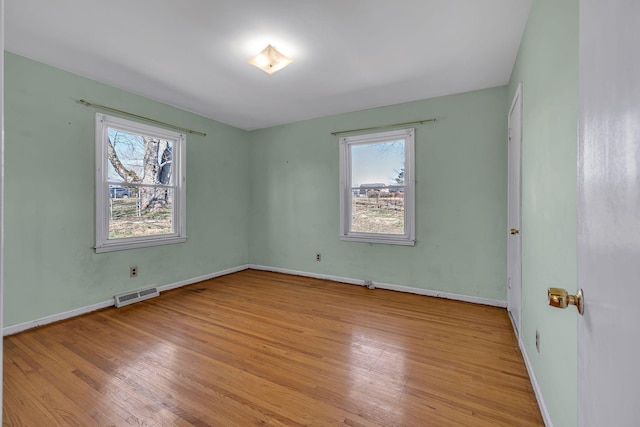 unfurnished bedroom featuring light wood-type flooring, baseboards, and visible vents