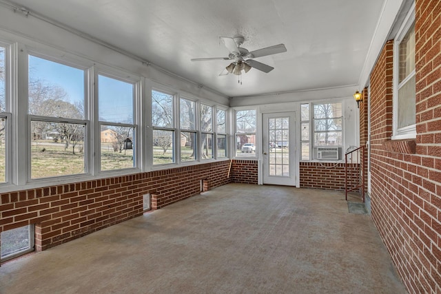 unfurnished sunroom with a ceiling fan and cooling unit