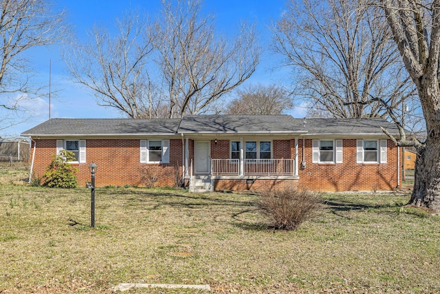 ranch-style house featuring brick siding, a porch, and a front yard