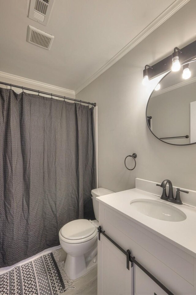 bathroom featuring visible vents, crown molding, and vanity