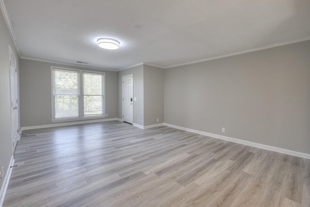 unfurnished room with light wood-type flooring, baseboards, and ornamental molding