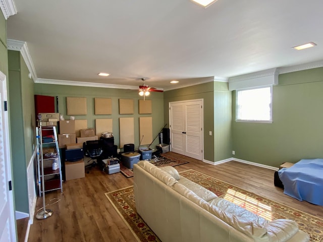 living area featuring ornamental molding, wood finished floors, a ceiling fan, and baseboards