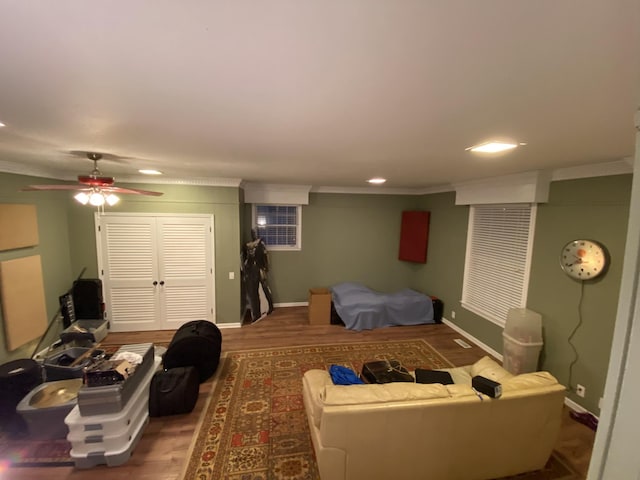 bedroom featuring a closet, crown molding, baseboards, and wood finished floors