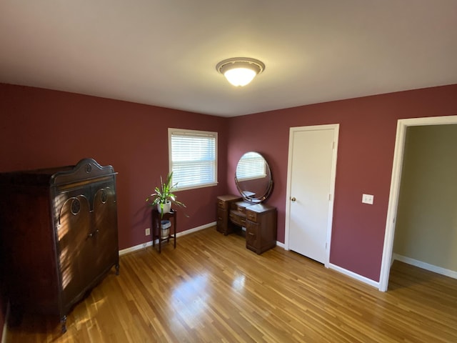 bedroom featuring light wood-style floors and baseboards