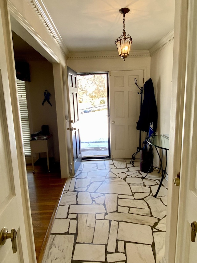 entryway featuring stone tile floors and crown molding