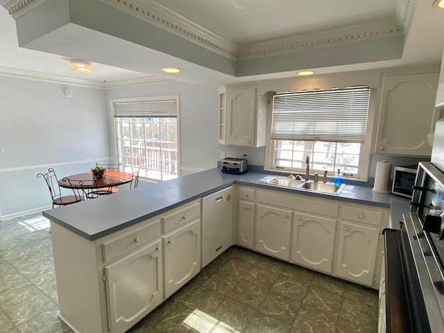 kitchen featuring dishwasher, a peninsula, and white cabinets