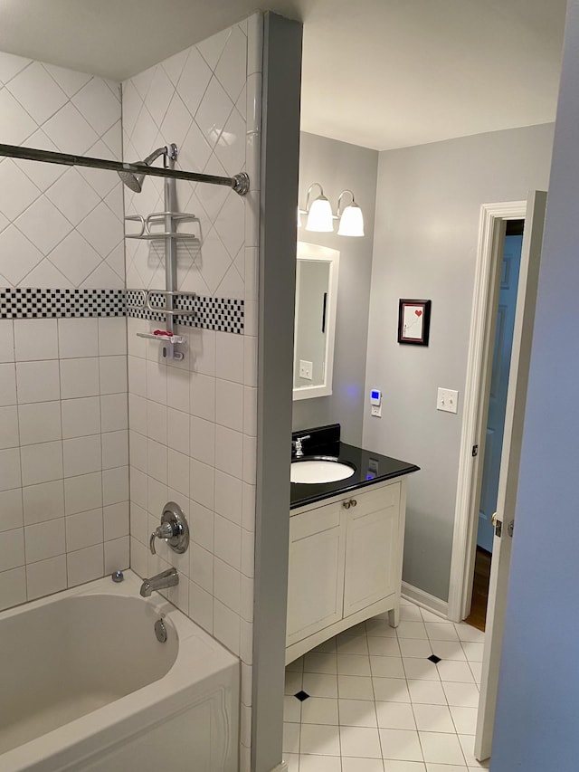 full bathroom with shower / bath combination, vanity, baseboards, and tile patterned floors