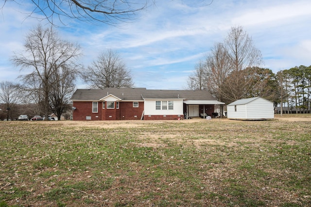 back of house with a storage shed, a lawn, crawl space, an outdoor structure, and brick siding