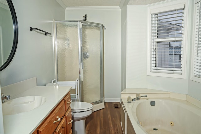 full bath featuring toilet, ornamental molding, a stall shower, vanity, and a whirlpool tub