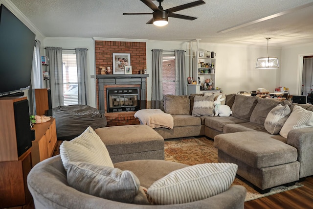 living area featuring a fireplace, ornamental molding, and a textured ceiling