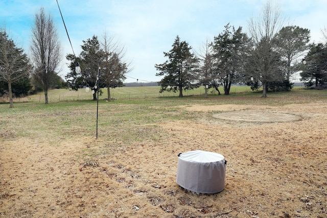 view of yard featuring a rural view and fence