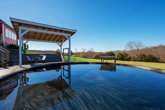 view of swimming pool with a yard