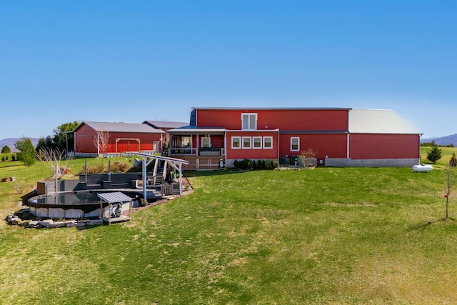 back of property with an outbuilding and a yard