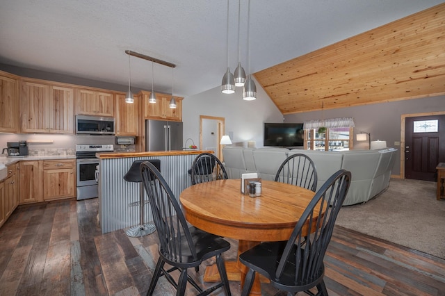 dining space with lofted ceiling and dark wood-style flooring