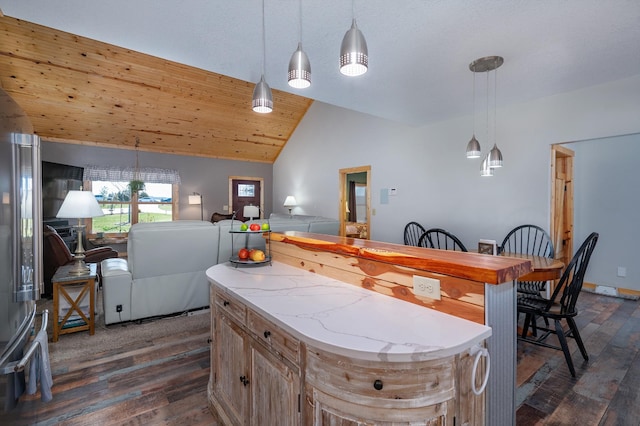 kitchen with lofted ceiling, open floor plan, light countertops, and hanging light fixtures