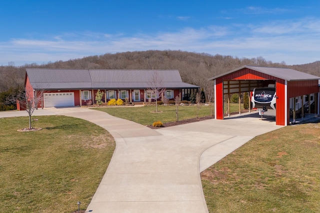 view of front of house with concrete driveway, an attached garage, and a front lawn