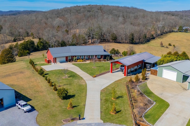 drone / aerial view featuring a wooded view