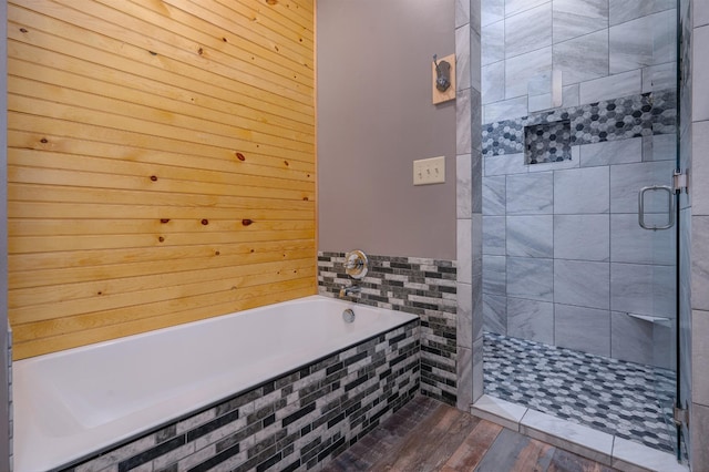 full bath with a tile shower and a garden tub