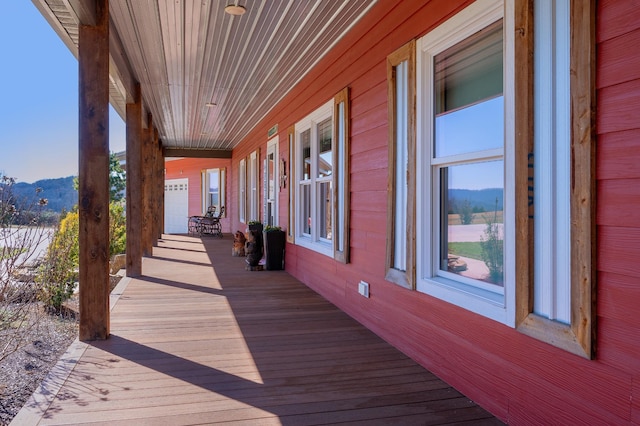 wooden terrace featuring covered porch and a mountain view