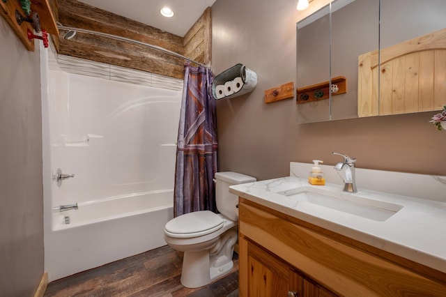 bathroom featuring toilet, wood finished floors, shower / bath combination with curtain, and vanity