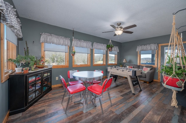 dining space with ceiling fan, dark wood-style flooring, a textured ceiling, and baseboards