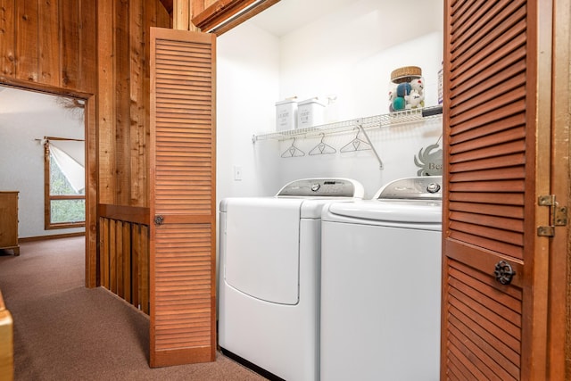 clothes washing area featuring laundry area, carpet flooring, and washing machine and clothes dryer