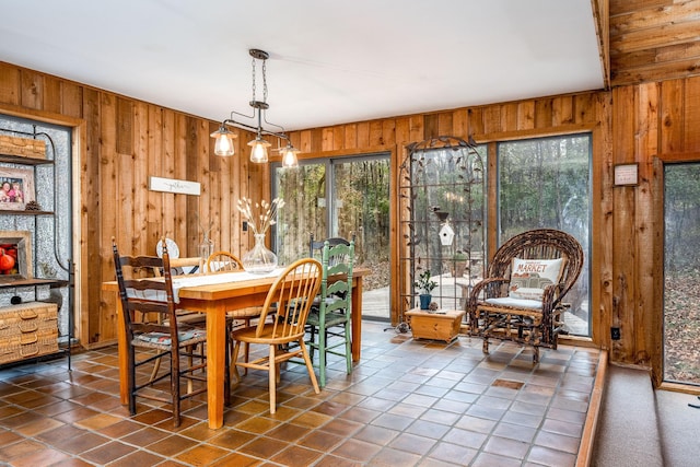 dining room with wooden walls