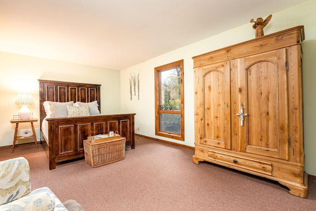 bedroom featuring carpet and baseboards